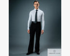 Full-length studio portrait of a male ballroom dancer wearing black Chrisanne Clover practice trousers, a white long-sleeve dance shirt, and a black tie against a grey backdrop.