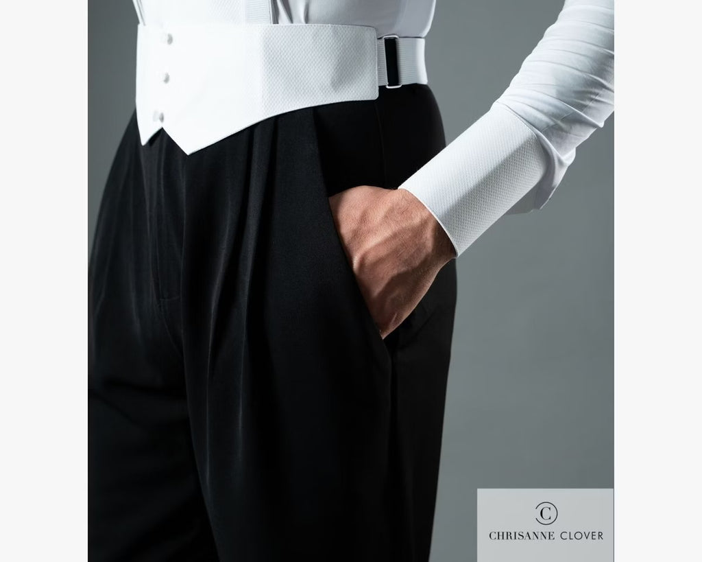 Close-up detail shot of the side pocket and crisp front pleats on the black Chrisanne Clover men's ballroom dance trousers, worn with a white waistcoat and shirt.