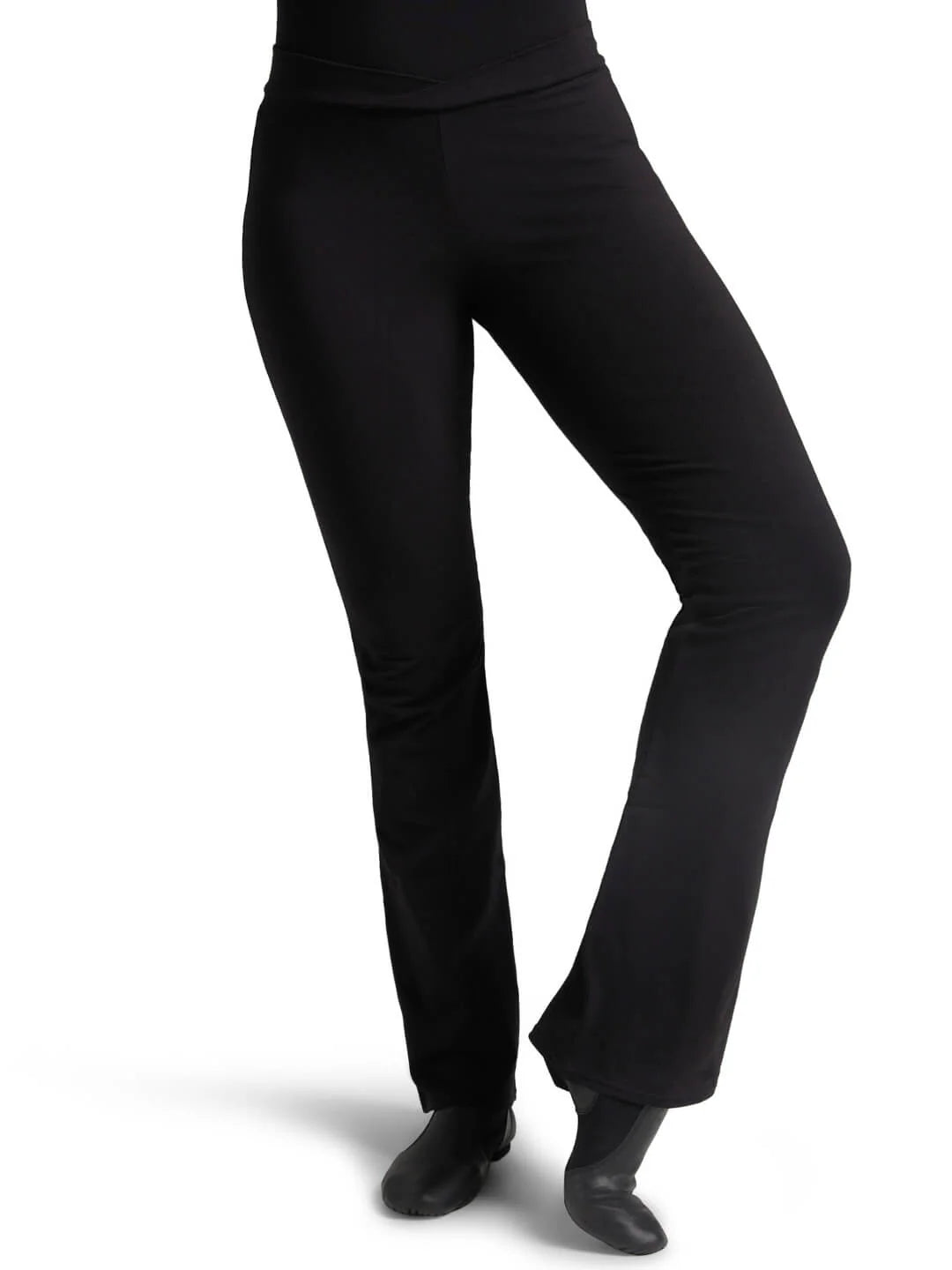 Front view of a dancer wearing black Capezio® Cotton V-Front Jazz Pants and jazz shoes, showing the flattering bootcut leg fit.
