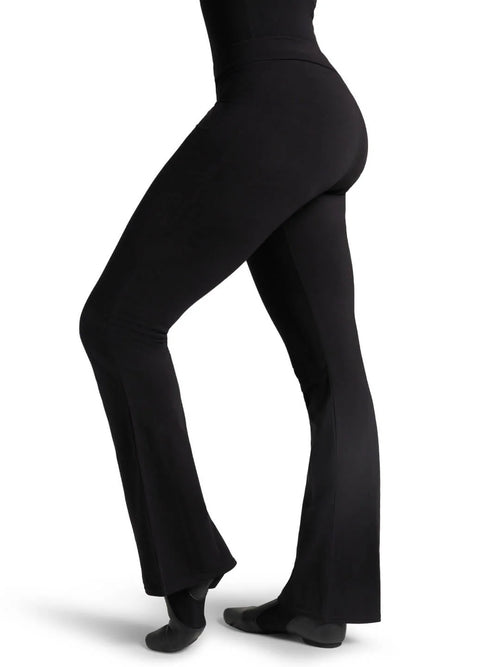 Side profile view of a fitness model wearing the black Capezio® CC750M jazz pants, showcasing the sleek lift and tailored hip-to-thigh compression.