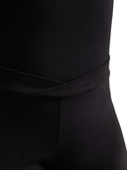 Close-up shot of the overlapping V-front waistband on the black Capezio® cotton dance pants, showcasing the cross-over style lines.