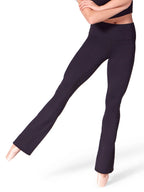 Front three-quarter view of a fitness model wearing black Capezio® Soft Elegance Flare Leggings with ballet shoes, showcasing the high-waisted fit and leg flare.