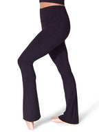 Side profile view of a model wearing the black Capezio® EL112W flare leggings, highlighting the supportive self-lined waistband and sleek thigh-to-calf compression.