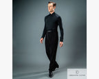 Full-length studio profile portrait of a male dancer wearing a black long-sleeve dance shirt and black Chrisanne Clover Latin practice trousers.