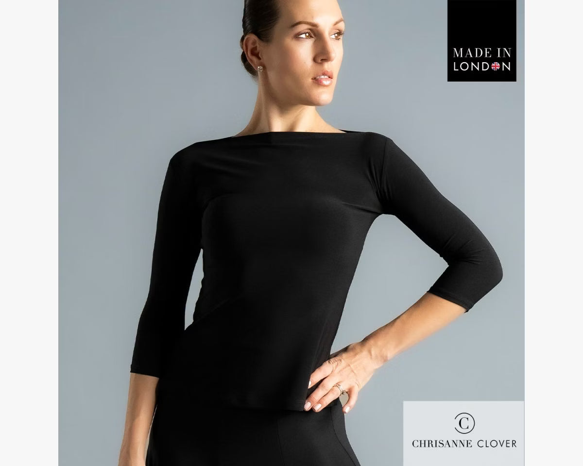 Close-up studio shot of a female dancer from the waist up, wearing the black Chrisanne Clover Eternity Top with 3/4 sleeves and a clean boat neckline against a grey background.
