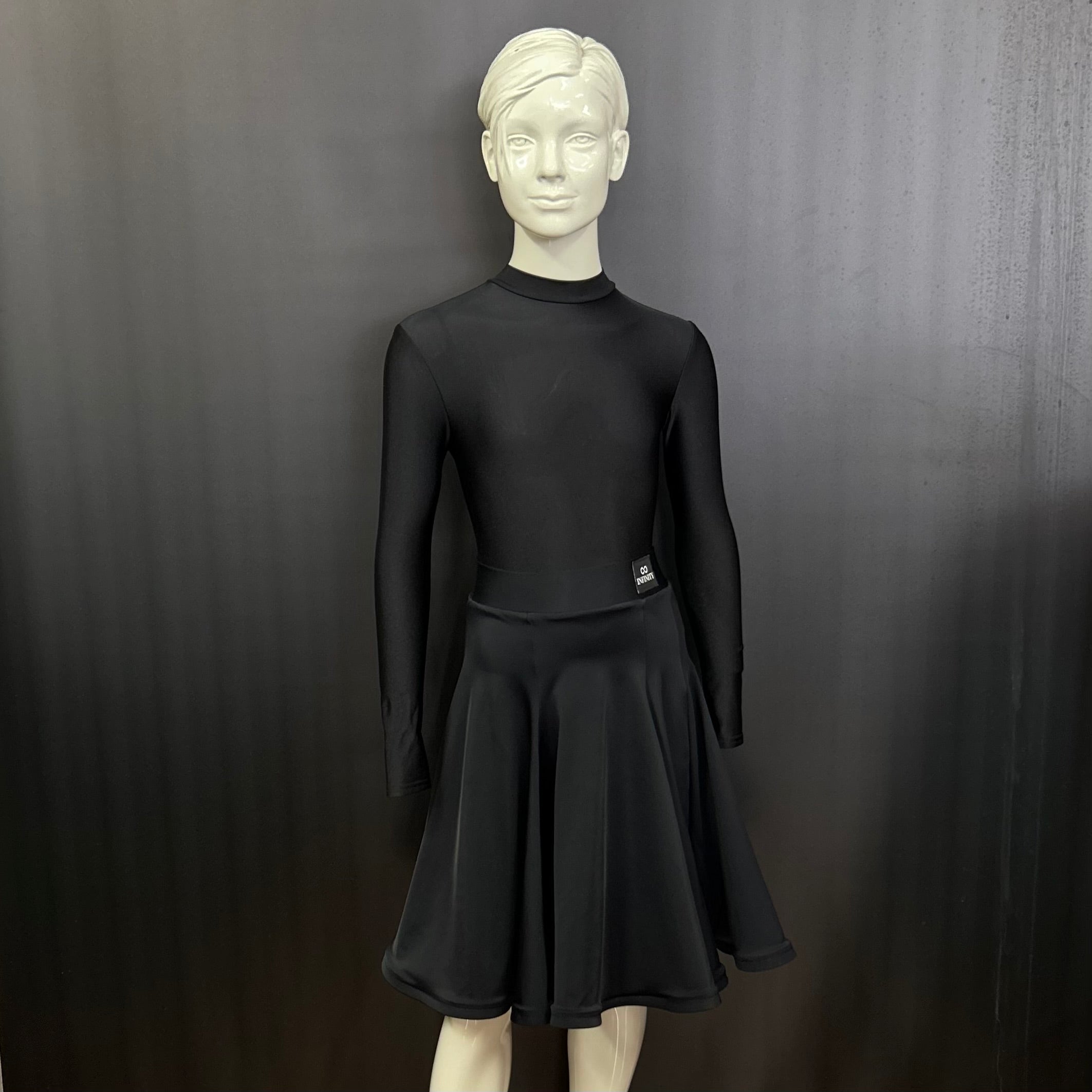 Front view of the Ellie juvenile black matt Lycra 6-panel dance practice skirt featuring a structured crinoline hemline on a studio mannequin.