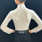 Person wearing a white blouse with a black belt labeled 'Pure Class' against a dark background