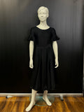 Front view of the Ellie juvenile black matt Lycra 6-panel practice skirt with satin hemline on a studio mannequin.