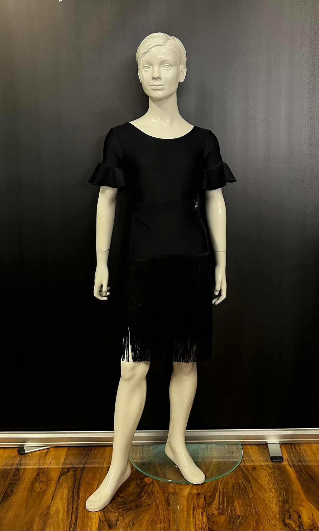 Electra girls Latin fringe skirt in black — front view, Blackpool Dance Store