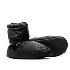 Black insulated Kids Warm Up Bootie by International Dance Shoes showing the cushioned upper, ankle strap, and signature brand logo tab and sole view on second shoe lying on its side.