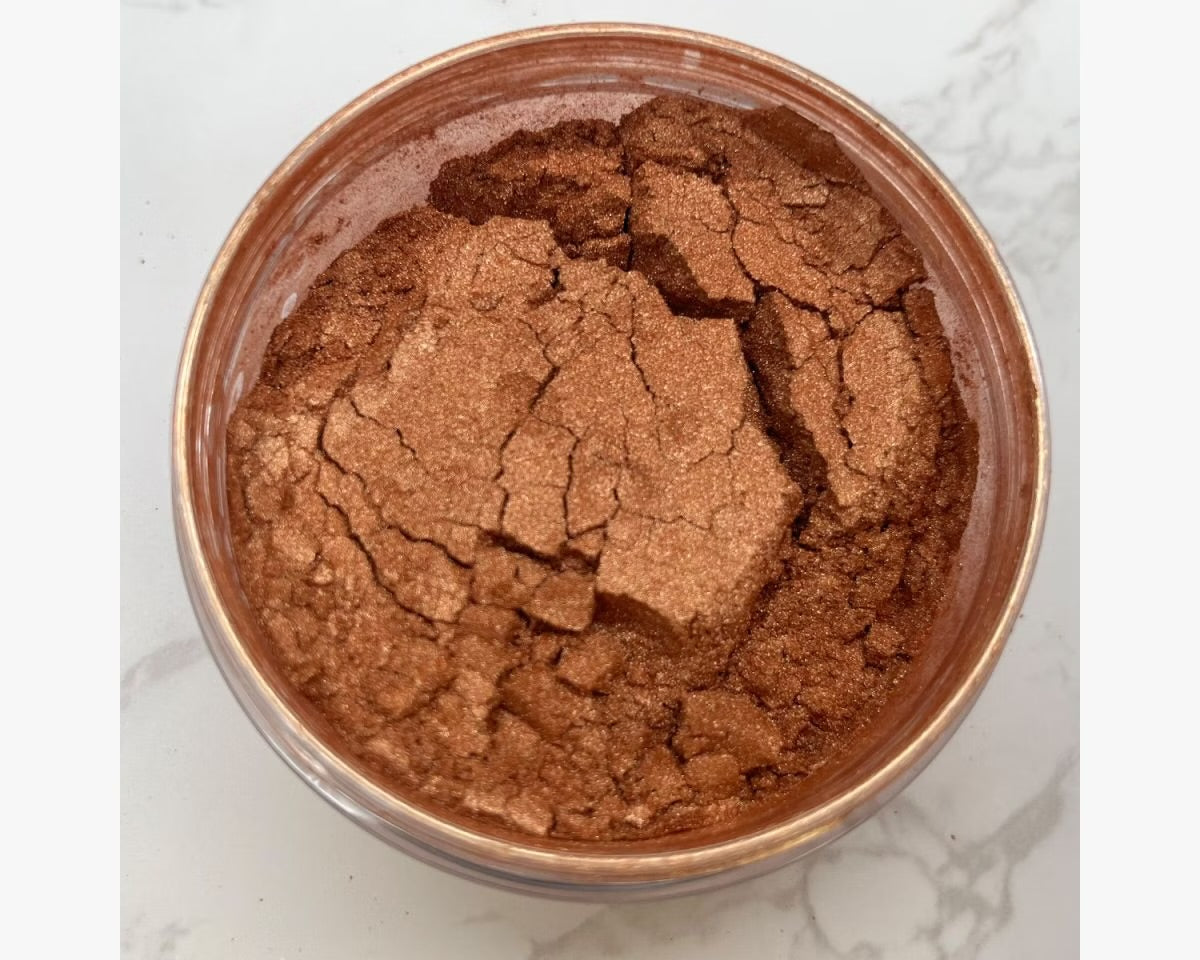 Aery Jo professional tanning powder pot displaying a deep bronzing shimmer shade for athletic dancesport skin tone definition.