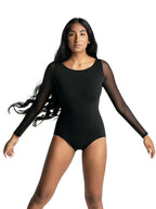 Studio action view of a female dancer posing in the black Capezio® long sleeve strappy back leotard, showing stretch, movement, and full front lining.