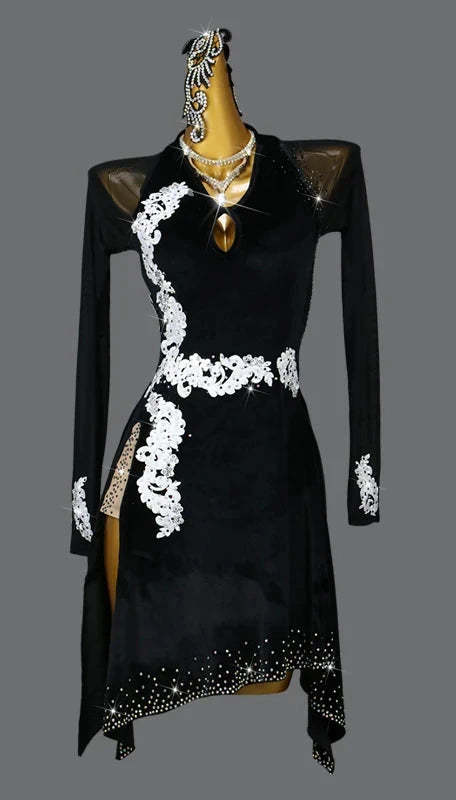 Black dress with white lace details on a mannequin against a gray background